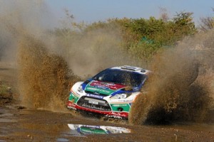 Mikko_Hirvonen_and_Jarmo_Lehtinen_powering_through_a_shallow_lake_in_the_Fiesta_WRC_on_day_three_of_the_2011_Mexico_rally_Ford_28069
