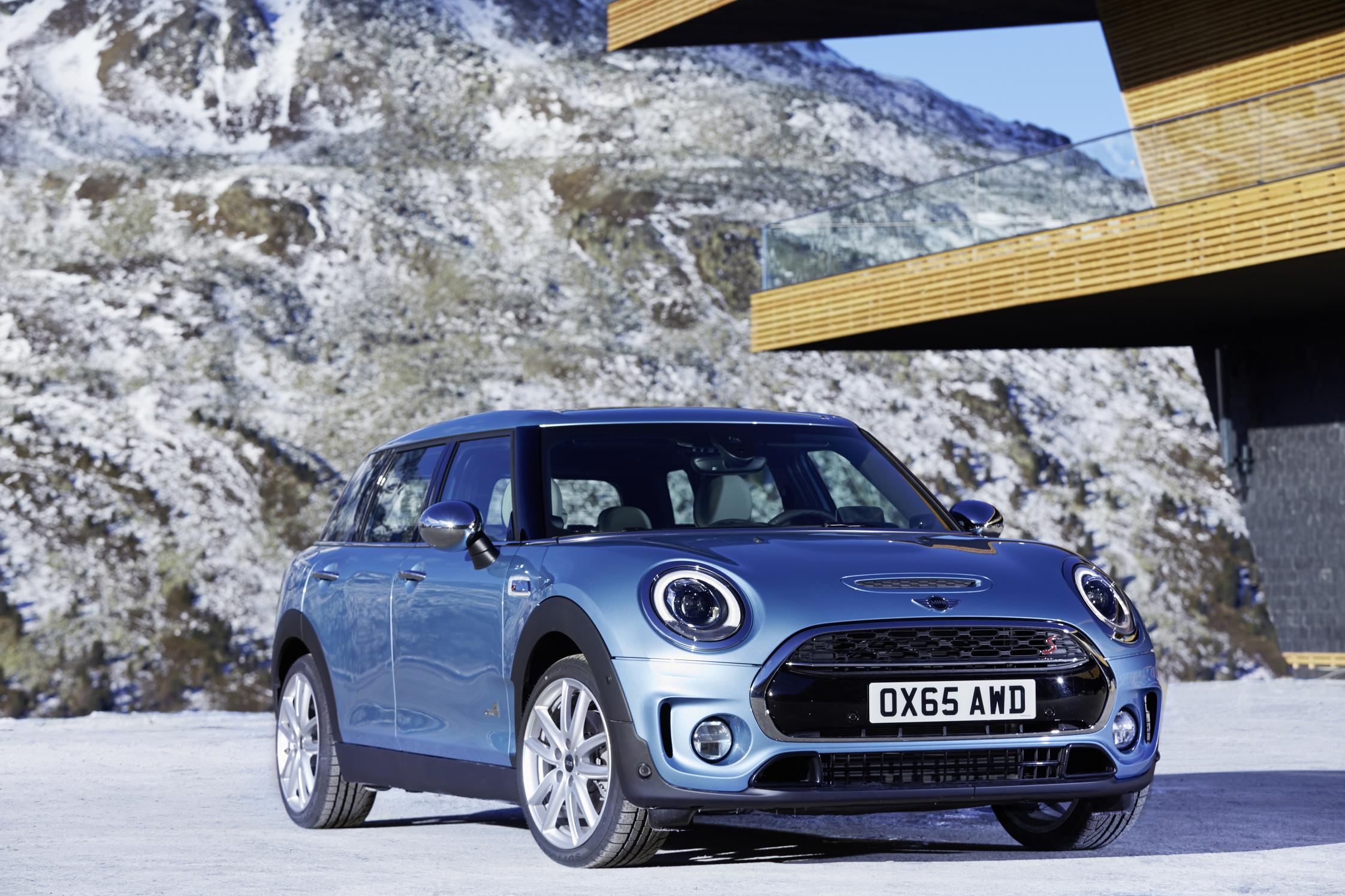 metallic MINI Cooper Clubman parked in front of mountains