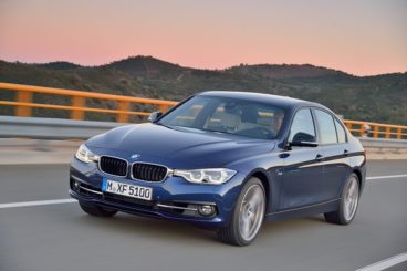 BMW 3 series blue metallic with sunset behind