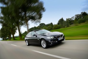 BMW 5 Series Saloon in black driving