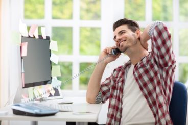 Man smiling whilst he's on the phone