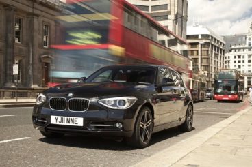 BMW 1 Series in black driving in London