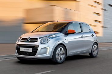 Silver Citroen C1 driving along a road