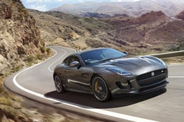 Jaguar F-Type Coupe side view driving up mountain