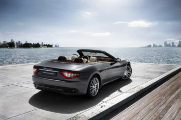 Maserati Gran Cabrio back view roof down parked by ocean