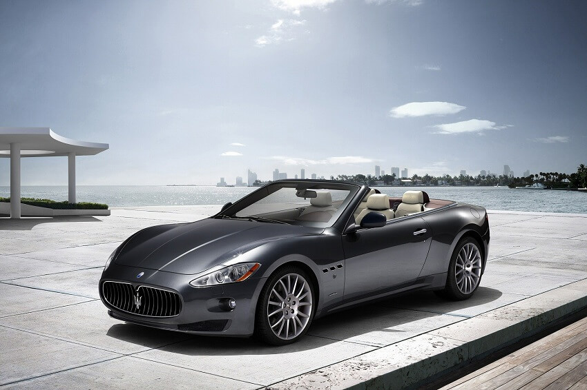 Maserati Gran Cabrio parked by ocean side view roof down