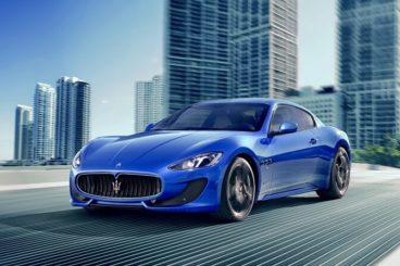 Maserati Granturismo blue paint driving out of city