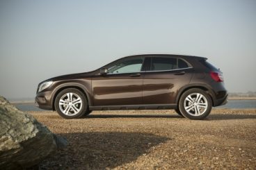 Mercedes GLA Class side view parked on a pebble beach