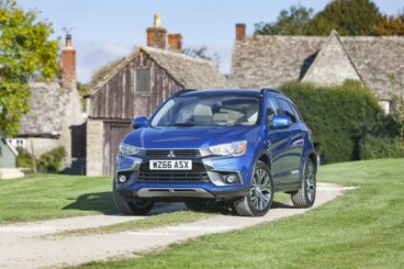 Blue Mitsubishi ASX front view parked in front of country house