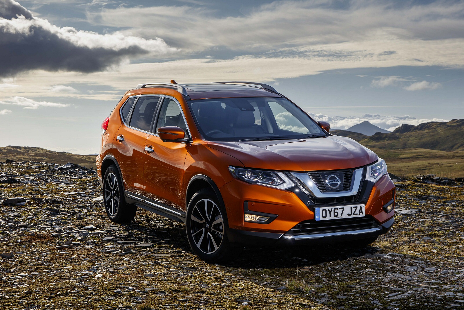 Nissan X Trail in orange parked offroad
