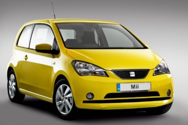 a yellow seat mii hatchback isolated on a white and silver background