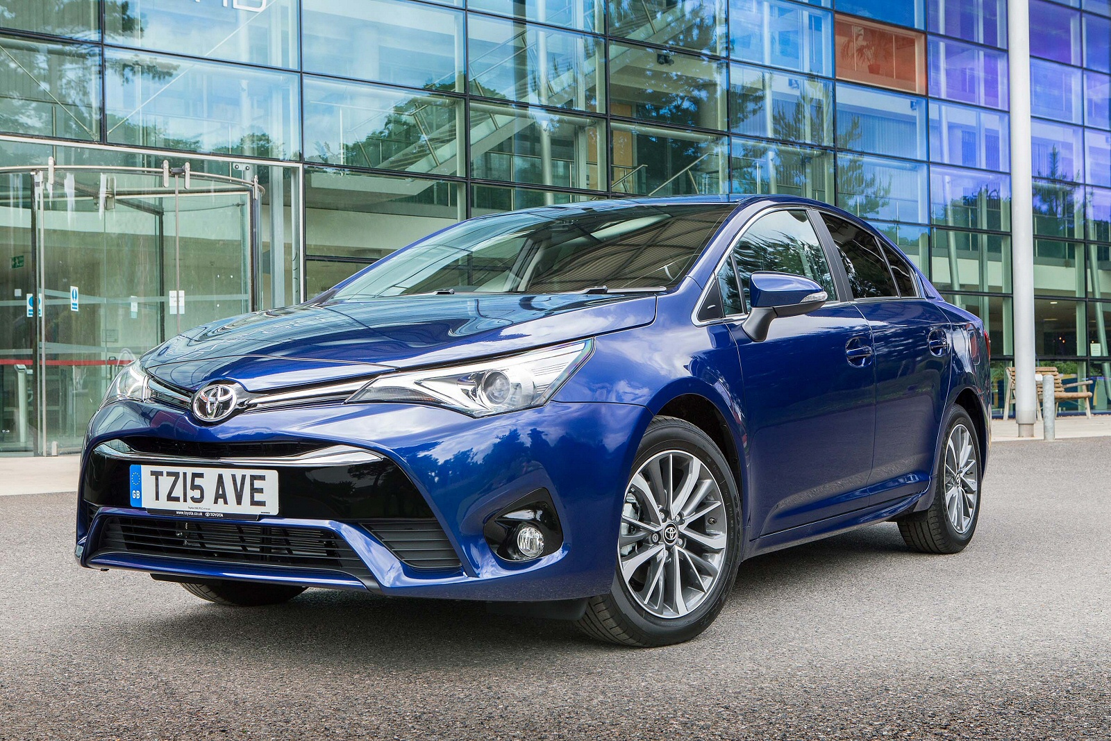 Dark Blue Toyota Avensis parked outside glass building