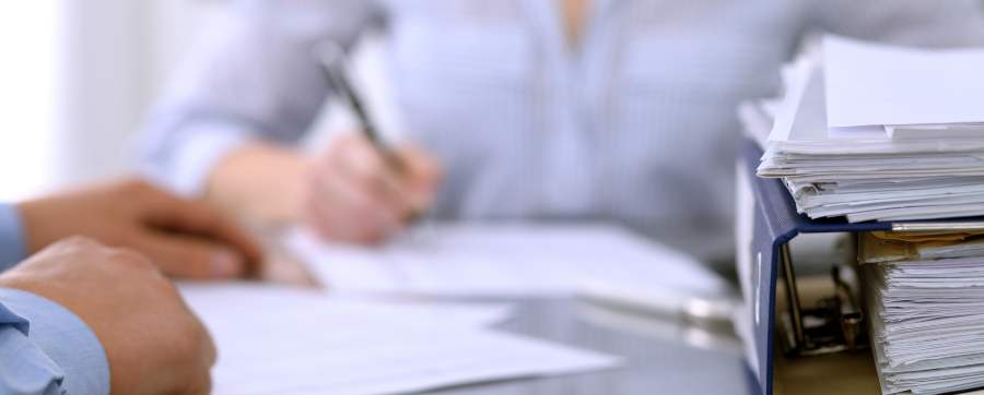 Woman going over a lot of paperwork
