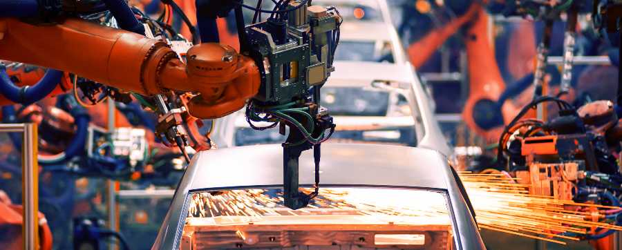 Robots working on cars in production line