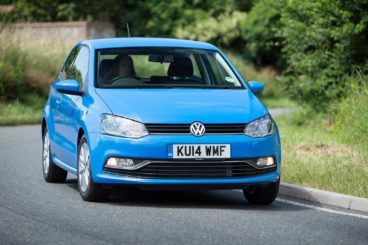 Volkswagen in sky blue driving along countryside