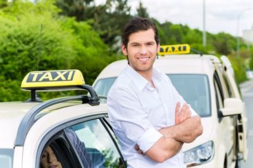 Man leaning on taxi
