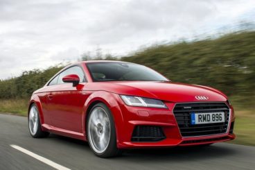 audi tt close up driving fast on road front view