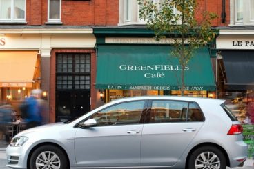 Volkswagen Golf parked in front of shops