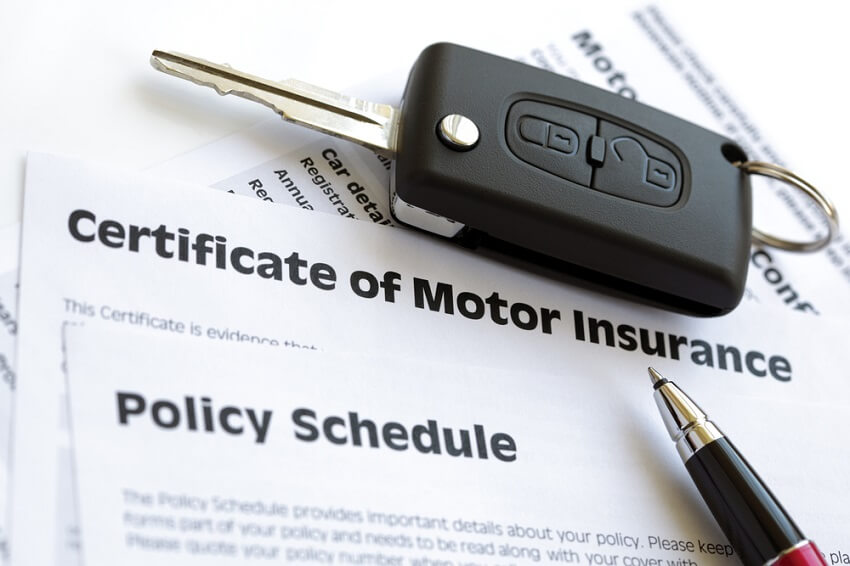 Car key on a certificate of motor insurance