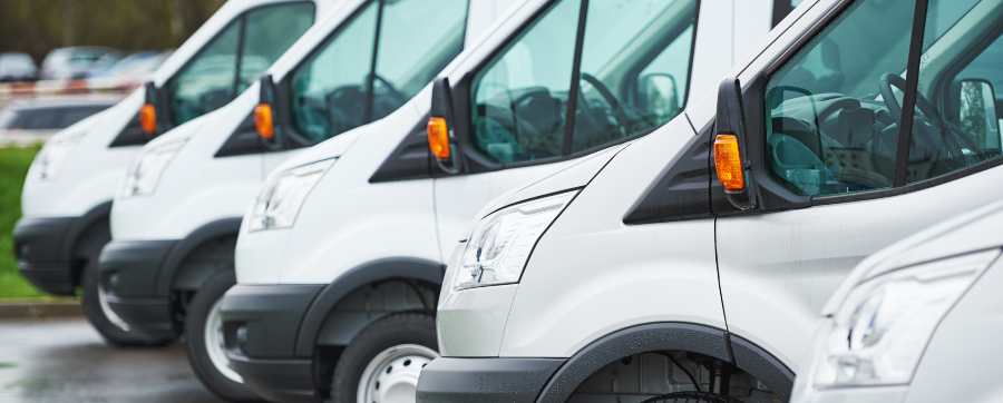 A row of white company vans