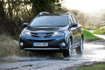 Black Toyota Rav4 Estate driving through a muddy puddle