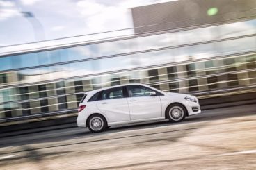 Mercedes B250e in white driving with background out of focus