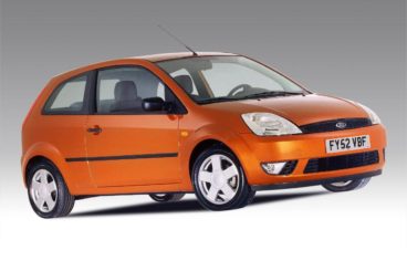 Orange Ford Fiesta in white showroom