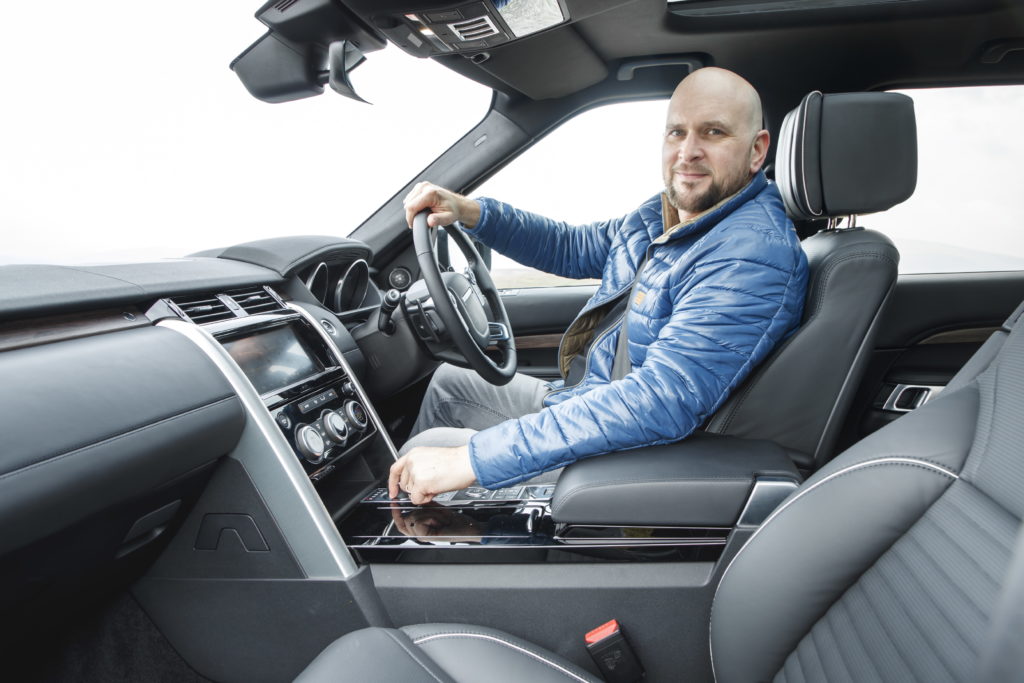 Tim sitting in the driver's seat of a Land Rover Discovery