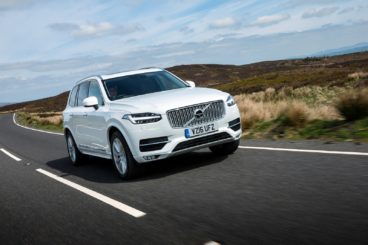 White Volvo XC90 driving on a country road
