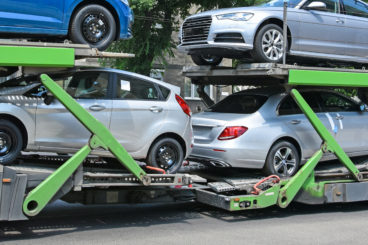 silver cars on a transporter