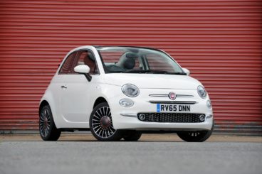 Fiat 500 C Convertible in white parked with red garage door behind