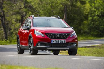 Red Peugeot 2008 driving round a corner