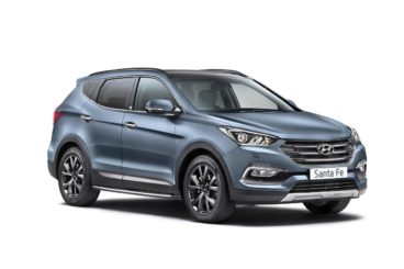 Hyundai santa fe in light blue metallic parked in showroom