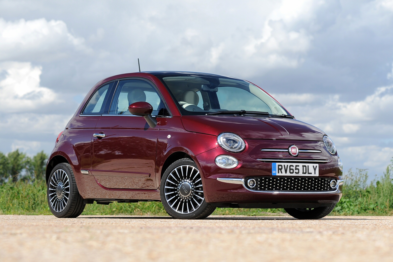 Purple Fiat 500 Off Road With Grass In The Background