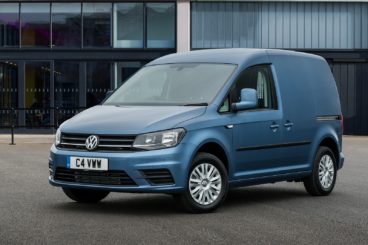 Blue Volkswagen Caddy parked outside a building