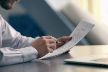 Man Looking at Documents - What Will Happen During My Call With OSV?