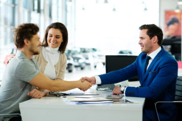 Shaking hands at a dealership