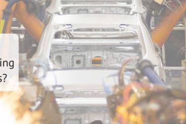 edited picture of cars on the assembly line with the title how are vehicle manufacturers preventing distraction to drivers