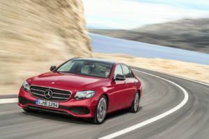 Mercedes E Class Saloon red driving on the road