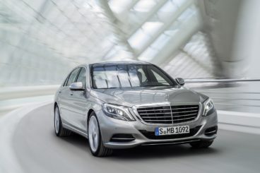 Silver Mercedes-Benz S-Class going through white tunnel