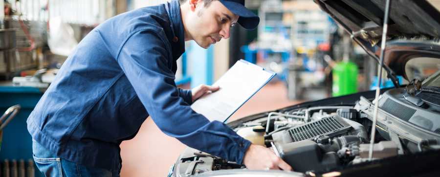 Mechanic inspecting engine