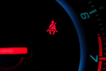 red seatbelt warning on dashboard of car