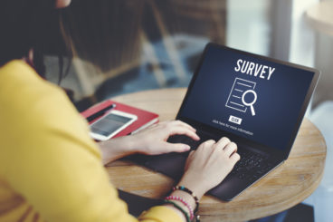 woman on her laptop taking part in a survey