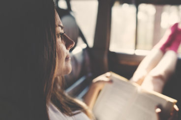 woman reading book in car - bizarre things