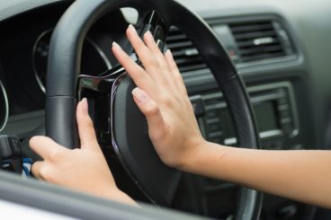 women using car horn whilst driving