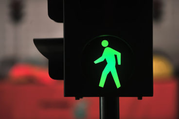 green pedestrian traffic light - driving in the dark