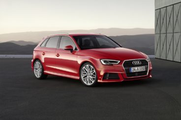 red audi s3 parked on tarmac at sunset with mountain in the background