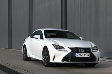 white lexus rc coupe with dark grey building in the background