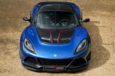 overhead picture of a bright blue lotus exige coupe parked on gravel driveway