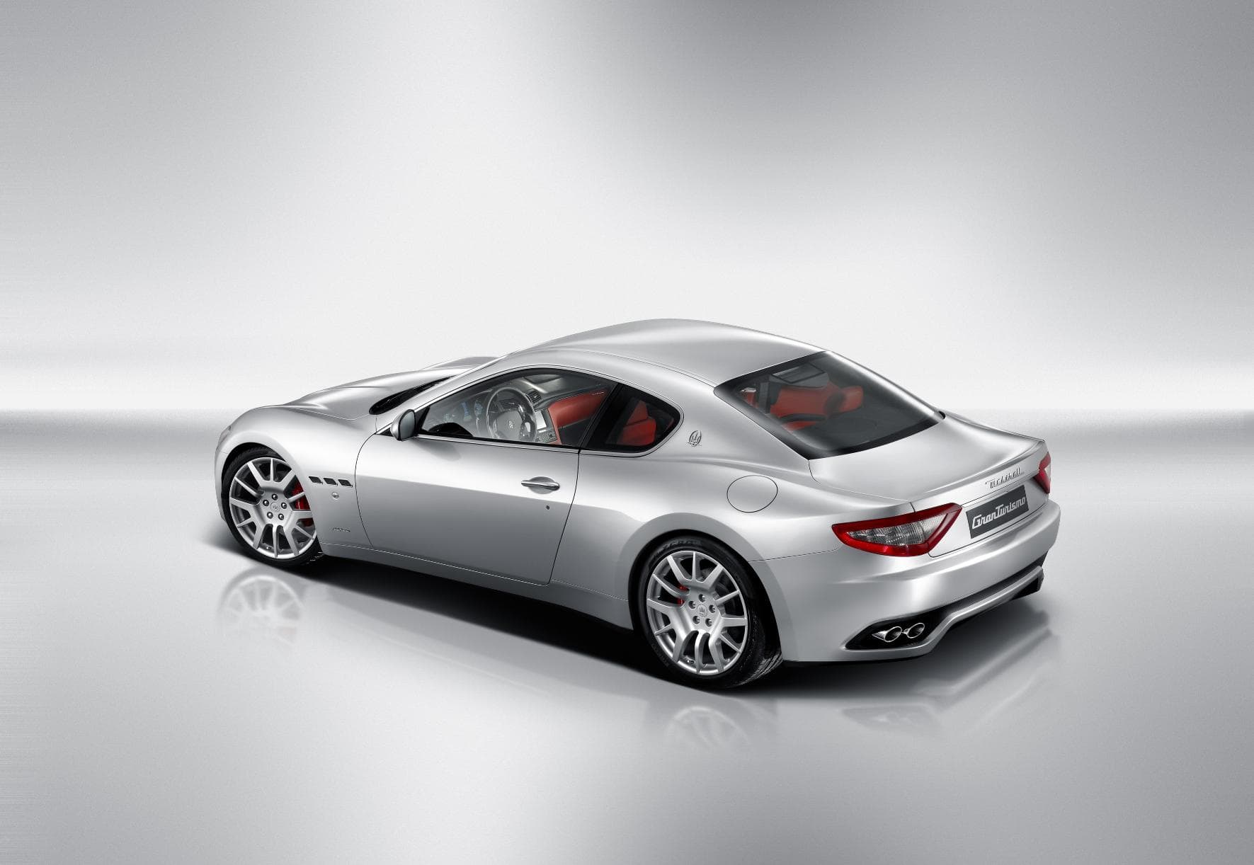 the back of a silver Maseratti GranTurismo Coupe isolated on silver background